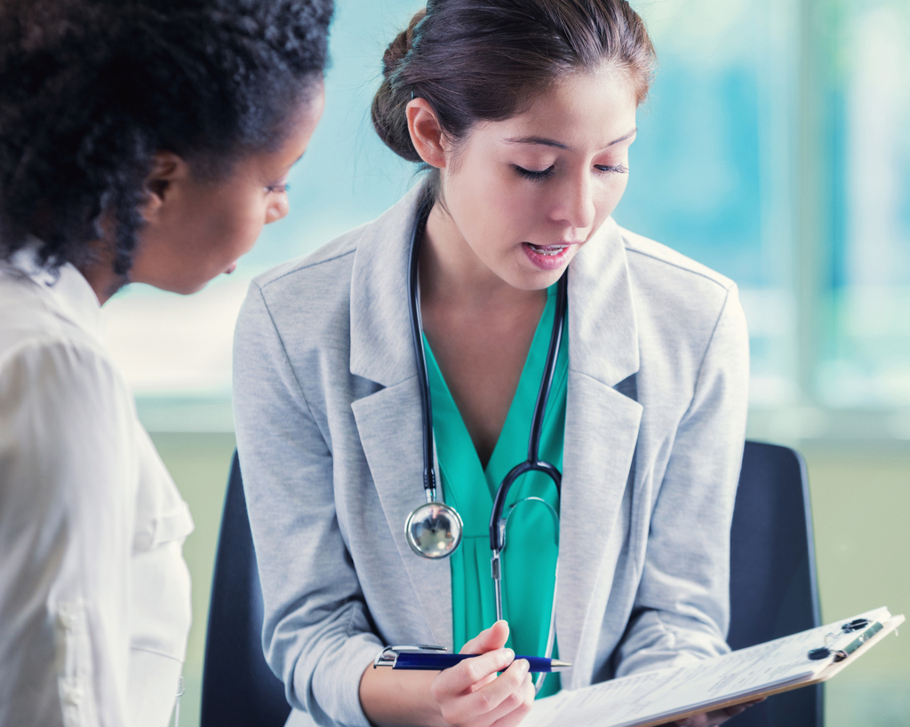 Confident doctor interviews woman for position in hospital